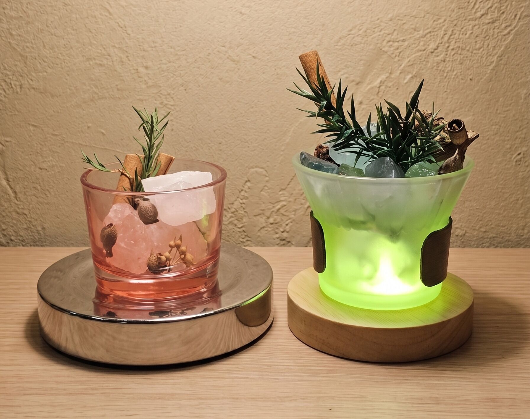 Two candle holders, one with a pink candle and the other with a green candle, both on wooden bases.