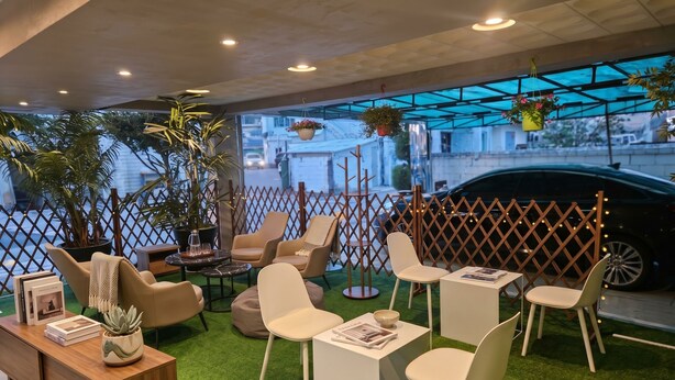 A modern indoor seating area with chairs, tables, and potted plants. - Propark Hotel Yeoju (Yeoju)