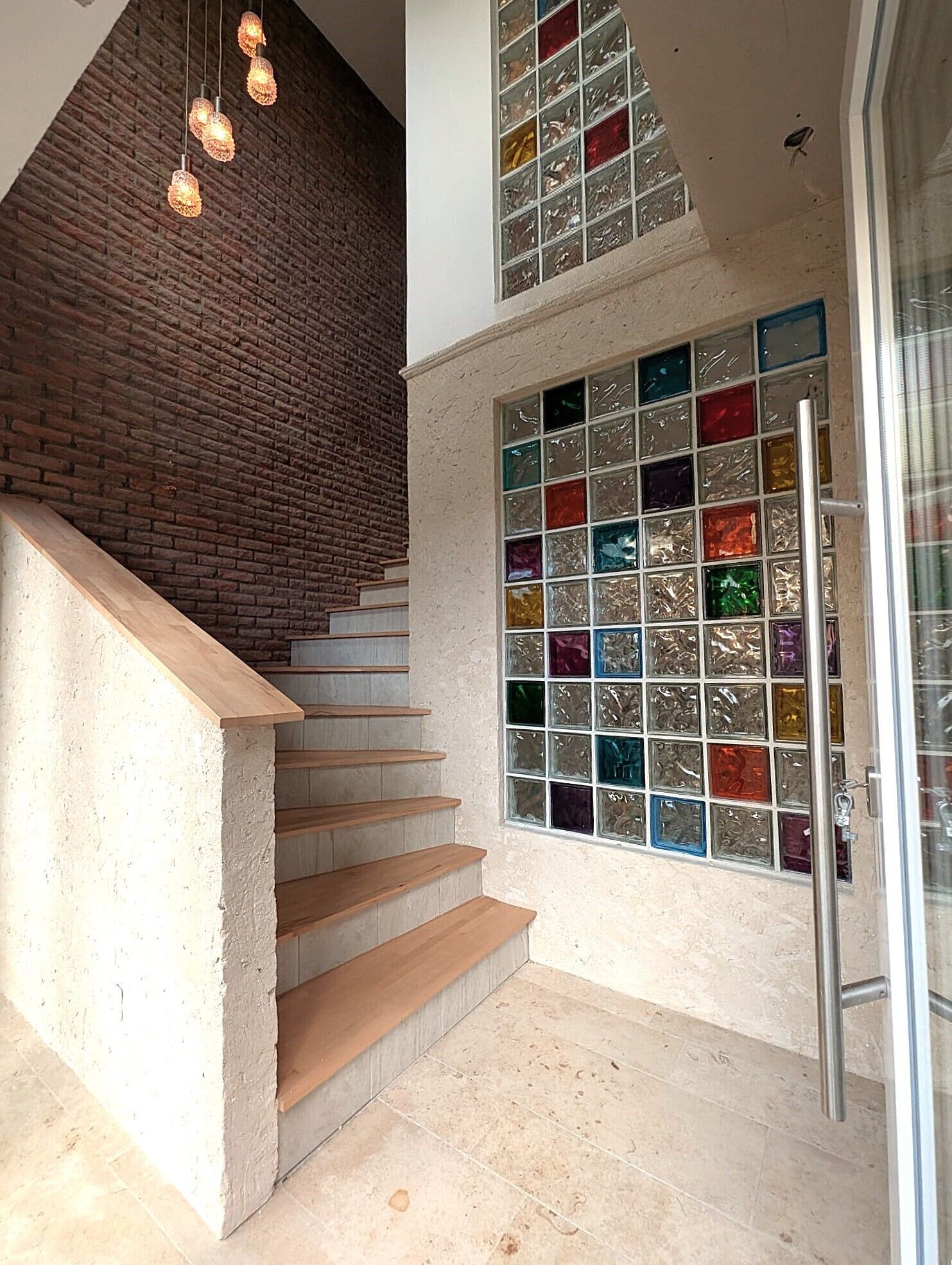 A staircase with wooden steps and a brick wall.