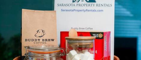 A basket with a coffee jar, a paper bag, and a box of coffee.