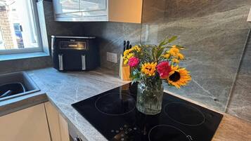Fridge, stovetop, coffee/tea maker, cookware/dishes/utensils