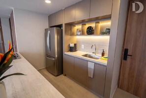 A modern kitchen with a built-in refrigerator, a sink, and a countertop. - Elegant, luminous and modern apartment in Zapopan (Zapopan)