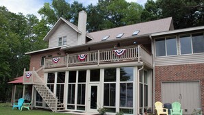 A two-story house with a covered porch, a garage, and a staircase leading to the upper level.