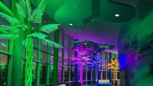 A spacious indoor area with a curved ceiling, large windows, and a seating area with cushions. - New Listing Discount! 1804 W Splash Beach Resort-1BR+Bunks-Gulf Views (Panama City Beach)