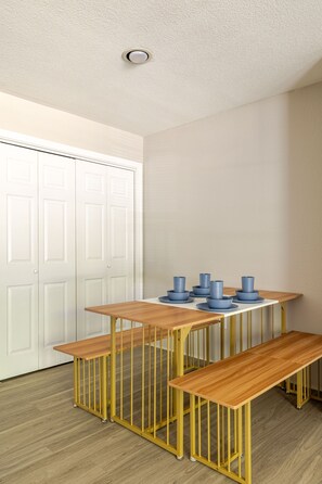 A room with a white door, a wooden table with benches, and a ceiling light fixture. - Best 1Bed 1Bath, 5 min walk to NRG /by Med Center (Houston)