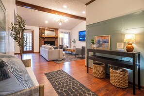 A living room with a sofa, a coffee table, a fireplace, a TV, and a lamp. - Wonderful 4-bedroom minutes from Trilith, QTS and U.S. Soccer Training Facility (Fayetteville)