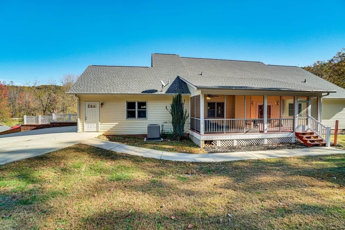 A single-story house with a front porch, a garage, and a small yard.