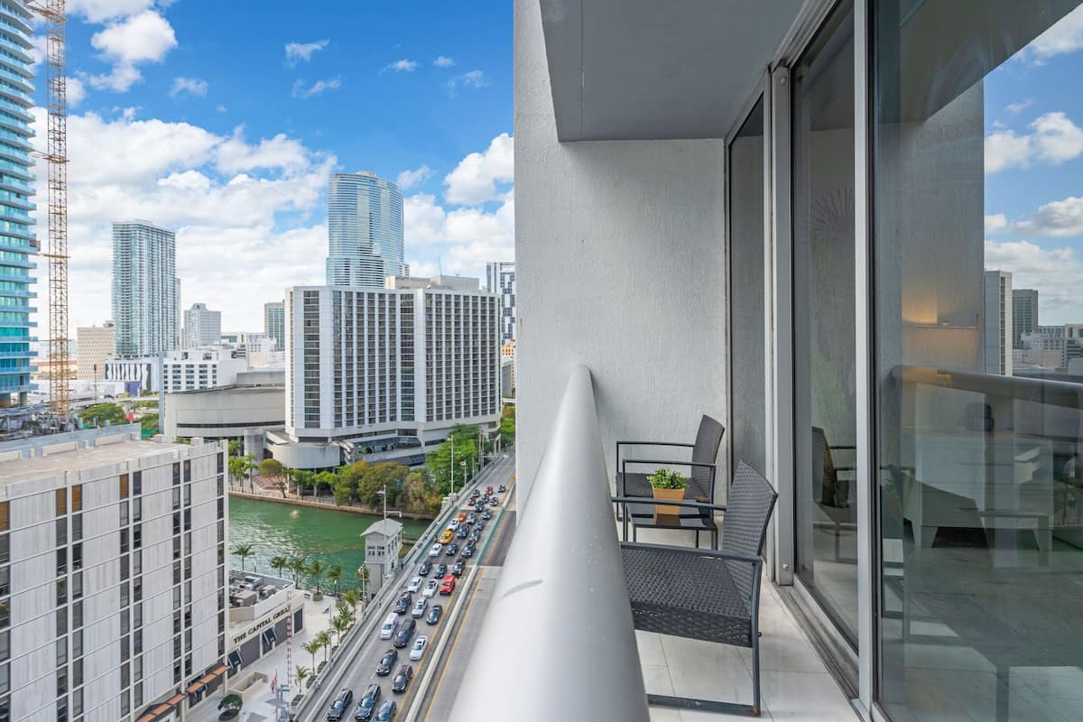 A high-rise building with a view of a busy street and other buildings.