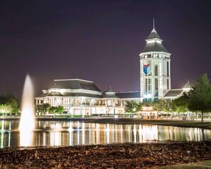 A large building with a prominent tower, a fountain in the foreground, and a calm body of water reflecting the structure. - Hilton Vacation Club St. Augustine (St. Augustine)