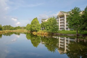 A building with multiple floors, balconies, and a reflection in the water. - Hilton Vacation Club St. Augustine (St. Augustine)