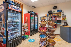 A vending area with coolers, baskets of snacks, and a Coca-Cola cooler. - Hilton Vacation Club St. Augustine (St. Augustine)