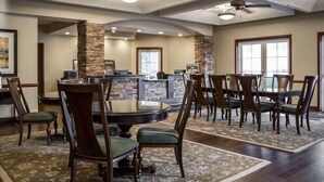 A spacious dining area with a stone accent wall, a counter, and a ceiling fan. - Hilton Vacation Club St. Augustine (St. Augustine)