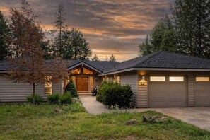 A residential property with a central entrance, two garages, and a well-maintained lawn. - AC, View of Golf Course, Ping Pong, by North Store (Sunriver)