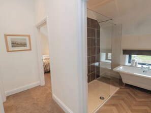 A modern bathroom with a glass-enclosed shower, a white sink, and a framed picture on the wall. - Harvest Cottage 2 (Berwick-upon-Tweed)