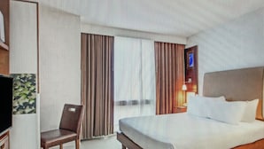 A hotel room with a bed, a chair, a TV, and curtains. - Cozy 1-bedroom condo with AC in peaceful New York.  For World Cup Soccer!! (New York)