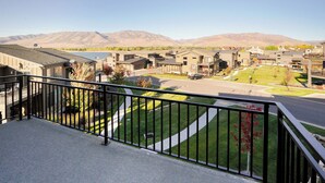 A residential area with modern houses, a clear sky, and mountains in the background. - Shred Reckoning | Pineview | Pool |  Hot Tub (Huntsville)