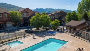 A pool area with two pools, a bench, and a chair. - Mountain Pass Retreat LS54 | Hot Tub| Lakefront (Huntsville)