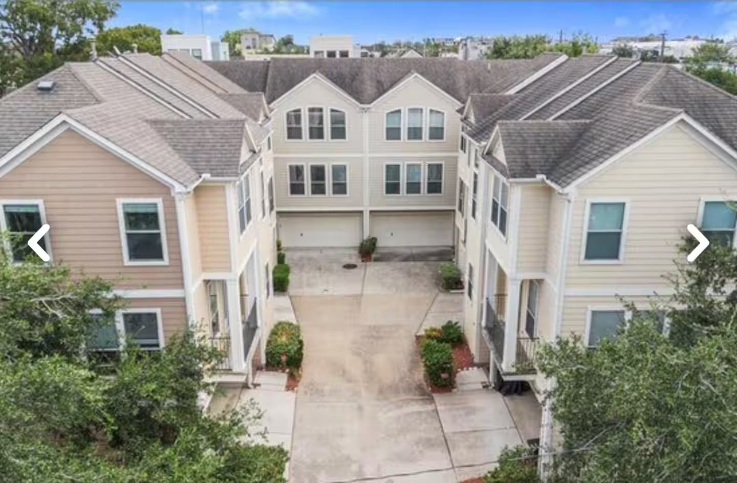 A residential building with a central courtyard, multiple entry points, and a garage.