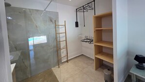 A modern bathroom with a glass shower enclosure, a wooden ladder, and a wooden shelf unit. - CASA FUNTA - villa T5 - vue mer- piscine (Sainte Lucie Porto-Vecchio)