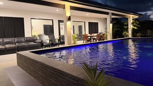 A modern house with a swimming pool, outdoor seating, and a patio area. - Villa Vonu - 2 Bedroom Ensuit. Your own pool, secured landscape near the beach. (Pacific Harbour)