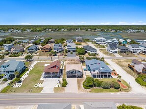 A coastal residential area with houses, a road, and a beach. - Shout! at the Shore: 4BR/2BA , Ocean Views, perfect for families! (Oak Island)