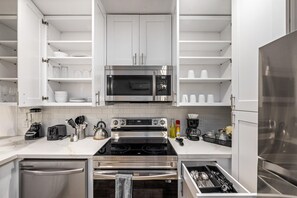 A modern kitchen with white cabinetry, stainless steel appliances, and a built-in oven. - Great Location, near Coffee shops<br>Pet-Friendly, 1BR | Museum District | Free Parking<br>newly renovated (Houston)