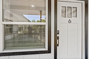A white door with a number '6' and a window with blinds. - Pet-Friendly Montrose 1BR | Museum District | Free Parking<br>newly renovated (Houston)