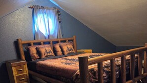 A bedroom with a wooden bed frame, a nightstand, and a dresser.