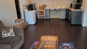 A living room with a sofa, a coffee table, and a rug.