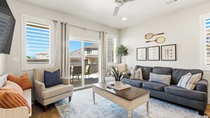 A living room with a sofa, armchair, coffee table, and a ceiling fan. - The Retreat Resort Amenities New Listing (Washington)