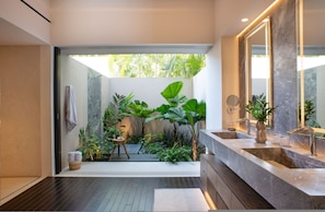 A modern bathroom with a large mirror, a sink, and a shower area. - Estate Buho in Punta Mita (Punta de Mita)