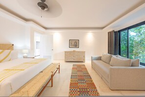 A bedroom with a bed, bench, dresser, sofa, and a patterned rug. - Condo Zazil in Punta Mita (Punta de Mita)