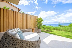 Eine Sitzgelegenheit aus Weidengeflecht mit Blick auf das Meer.
