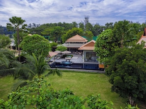 A resort with a swimming pool, outdoor seating, and lush greenery. - Banyan Tree Grand Residences by Banyan Living (Choeng Thale)
