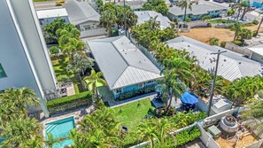 A residential area with multiple houses, a swimming pool, and a fenced yard. - 🌴 Crabby Bungalow | Duplex Unit, Walk to Crescent Beach, & Hot Tub (Siesta Key)