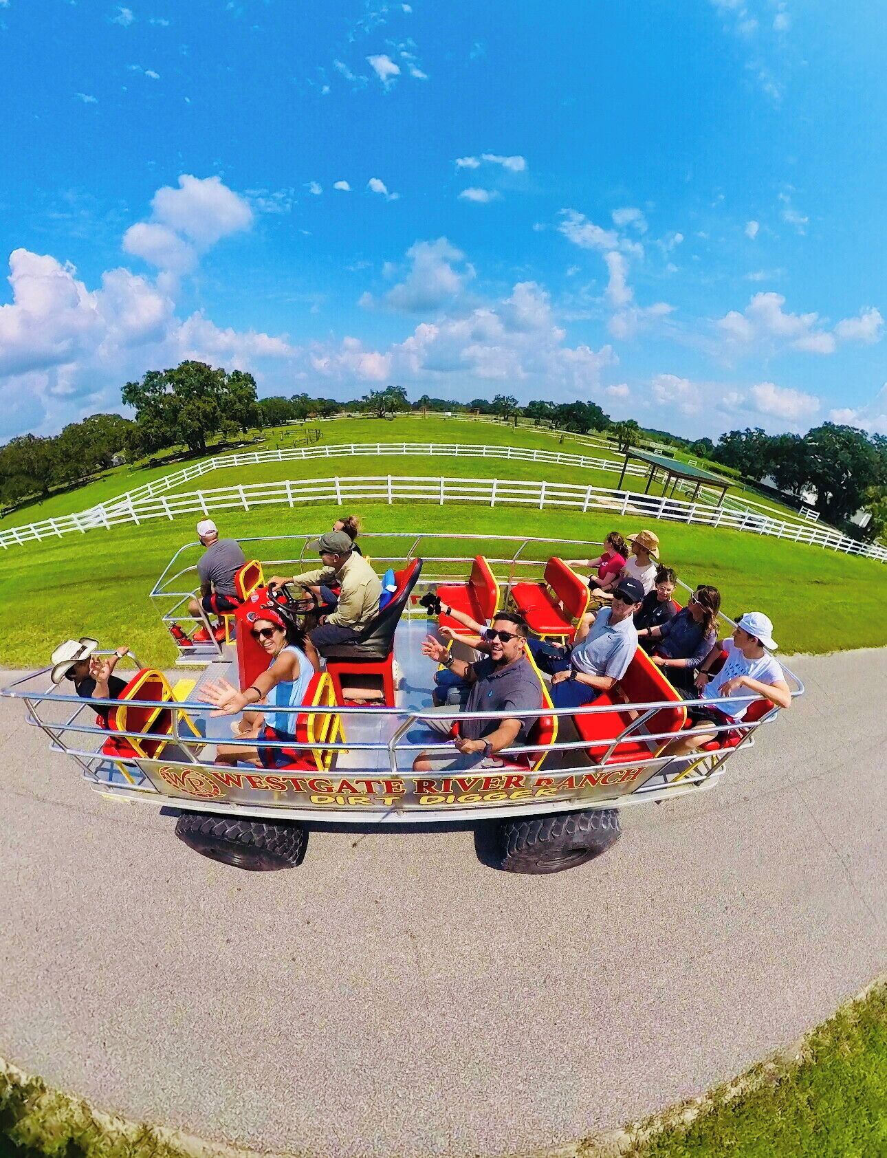 A group of people in a red and yellow amusement ride with "Westgate River Digger" written on it.