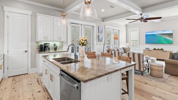 A modern kitchen with white cabinetry, a granite countertop, and a built-in dishwasher. - A Wavy Days | 5BR 30A | Steps to Pool | Sleeps 12 | Golf Cart + Bikes (Santa Rosa Beach)