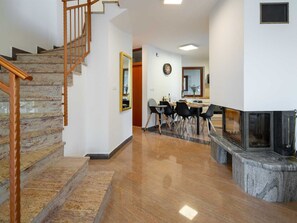 A modern interior with a staircase, dining area, and fireplace. - Charming Villa Rea, 8+2 with heated pool by Interhome (Donje Rastane)