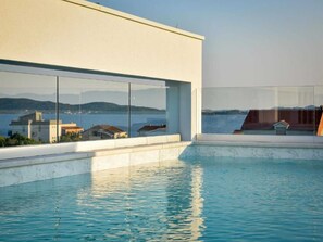 A modern building with a pool and a view of the sea. - Apartment  by Interhome (Zadar/Bibinje)