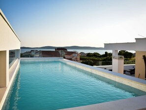 A rooftop swimming pool with a view of the sea and surrounding buildings. - Apartment  by Interhome (Zadar/Bibinje)