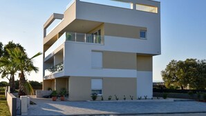 A modern multi-story building with balconies, a flat roof, and a clear sky. - Apartment  by Interhome (Zadar/Bibinje)