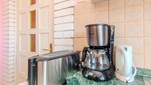 A kitchen with a toaster, a coffee maker, and a white kettle on a marble countertop. - Villa Annamaria with large pool, Zadar by Interhome (Crno)