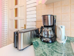 A kitchen with a toaster, a coffee maker, and a white kettle on a marble countertop. - Villa Annamaria with large pool, Zadar by Interhome (Crno)