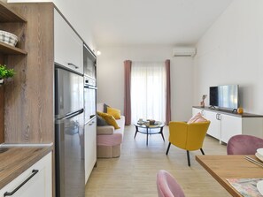 A modern apartment with a kitchen, living area, and dining space. - Apartment  by Interhome (Vir)