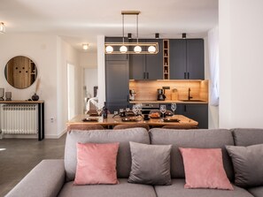 A modern kitchen with a central island, dark cabinets, and pendant lighting. - Villa Niko with heated pool by Interhome (Pridraga)
