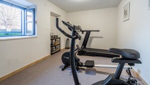 A home gym with a treadmill, elliptical, and weights. - Villa Niko with heated pool by Interhome (Pridraga)