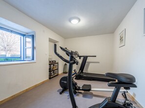 A home gym with a treadmill, elliptical, and weights. - Villa Niko with heated pool by Interhome (Pridraga)
