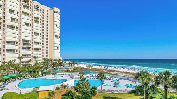 A hotel with a pool, beach, and ocean view. - Beautifully Decorated 2BR 2BA BEACHFRONT Condo! (Miramar Beach)