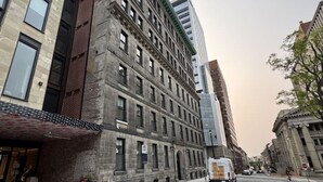 A multi-story building with a brick facade, large windows, and a flat roof. - 2Bed 2.5Bath Pet Friendly Townhouse Downtown Halifax (Halifax)