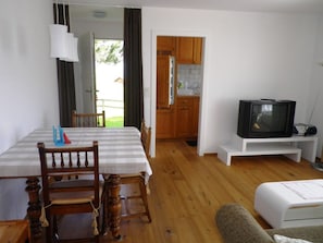 A room with a dining table, chairs, a television, and a kitchenette. - La Sclarida Kissling, (Segnas/Disentis), 1630 by Interhome (Disentis)